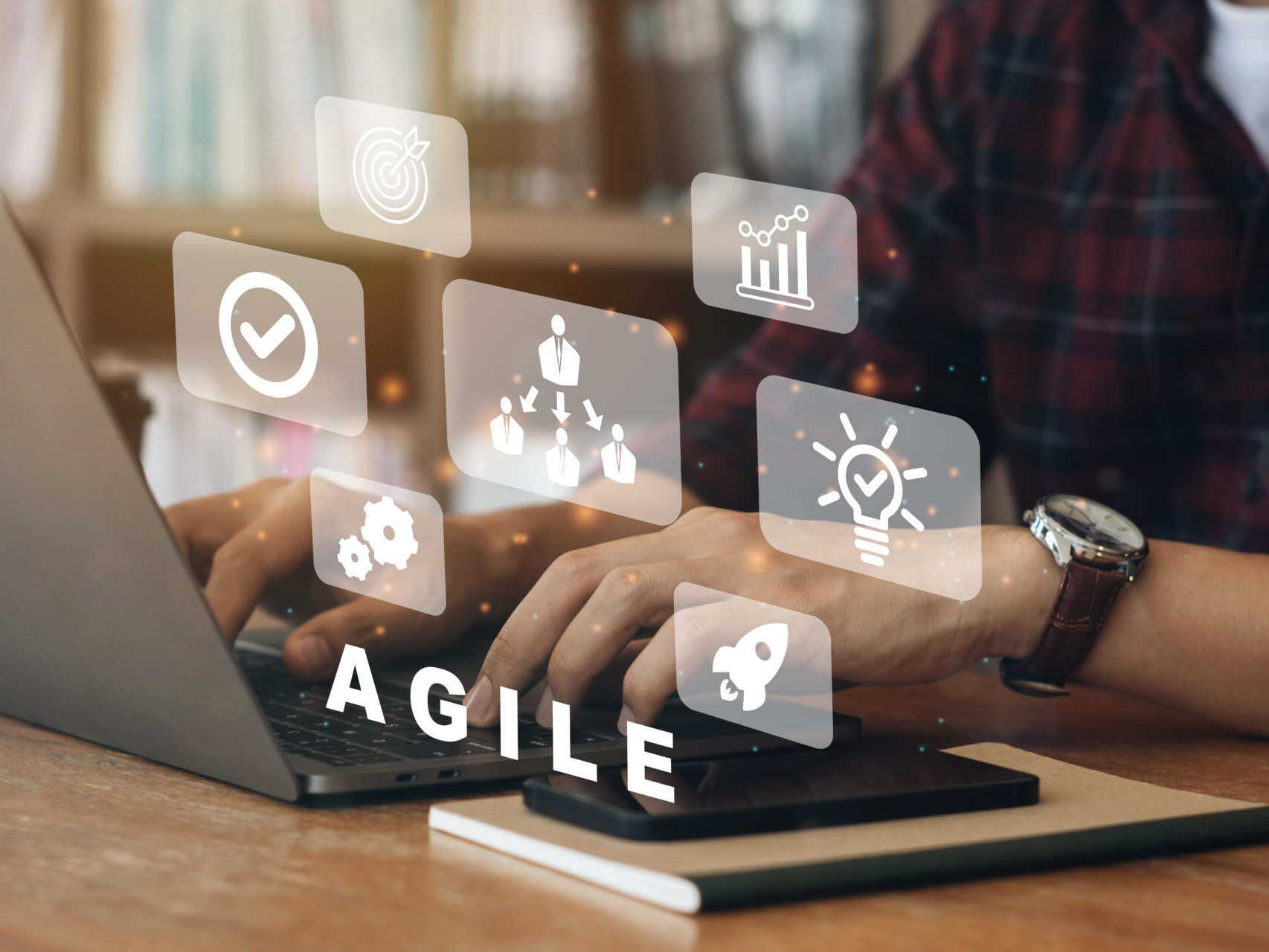Person working on computer with icons of Agile development methodology concept on virtual screen. Technology concept. 